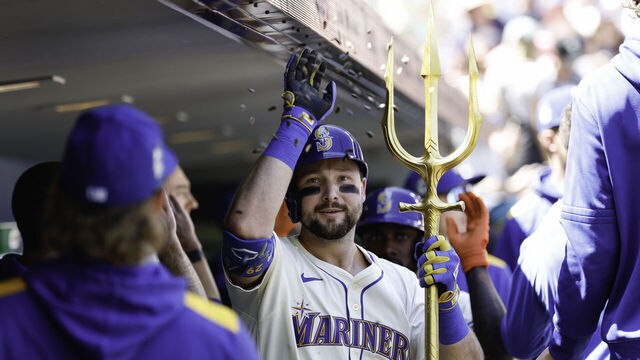 SEATTLE, WASHINGTON - AUGUST 10: Cal Raleigh #29 of the Seattle Mariners celebrates with teammates in the dugout after hitting a two-run home run during the first inning against the Tampa Bay Rays at T-Mobile Park on August 10, 2025 in Seattle, Washington.