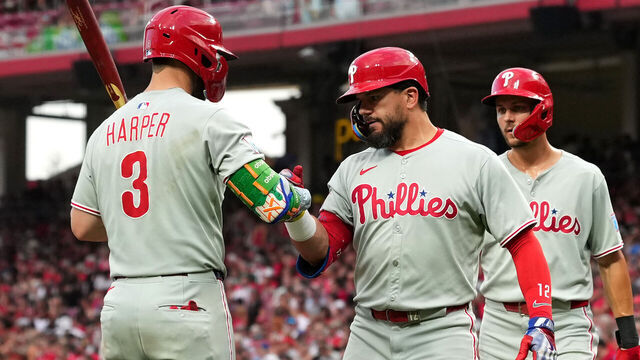 CINCINNATI, OHIO - AUGUST 11: Kyle Schwarber #12 of the Philadelphia Phillies celebrates a two run home run with Bryce Harper #3 of the Philadelphia Phillies during the eighth inning against the Cincinnati Reds at Great American Ball Park on August 11, 2025 in Cincinnati, Ohio.