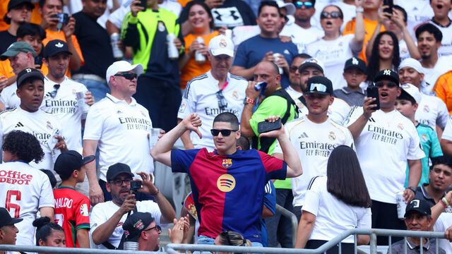 CHARLOTTE, NORTH CAROLINA - JUNE 22: A fan wearing a Barcelona shirt is seenin the middle of the Real Madrid fans during the FIFA Club World Cup 2025 group H match between Real Madrid CF and CF Pachuca at Bank of America Stadium on June 22, 2025 in Charlotte, North Carolina.