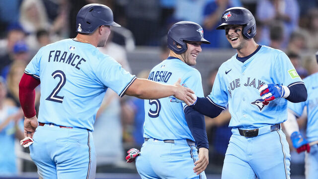 TORONTO, ON - AUGUST 12: Ernie Clement #22 of the Toronto Blue Jays celebrates a three-run home run with Ty France #2 and Daulton Varsho #5 against the Chicago Cubs during the fourth inning in their MLB game at the Rogers Centre on August 12, 2025 in Toronto, Ontario, Canada.