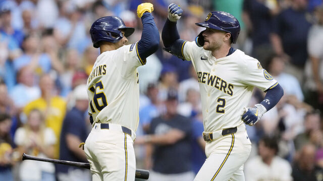 MILWAUKEE, WISCONSIN - AUGUST 12: Brice Turang #2 of the Milwaukee Brewers celebrates his solo home run with Blake Perkins #16 against the Pittsburgh Pirates in the fourth inning at American Family Field on August 12, 2025 in Milwaukee, Wisconsin.
