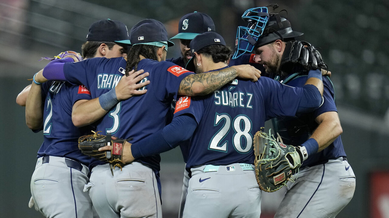 BALTIMORE, MARYLAND - AUGUST 12: Cole Young #2, Josh Naylor #12, J.P. Crawford #3, Andrés Muñoz #75, Eugenio Suárez #28, and Cal Raleigh #29 of the Seattle Mariners celebrate after winning a game against the Baltimore Orioles at Oriole Park at Camden Yards on August 12, 2025 in Baltimore, Maryland.