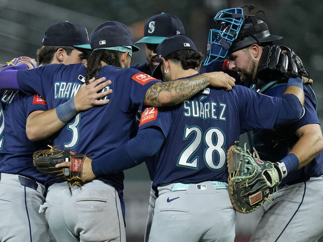 BALTIMORE, MARYLAND - AUGUST 12: Cole Young #2, Josh Naylor #12, J.P. Crawford #3, Andrés Muñoz #75, Eugenio Suárez #28, and Cal Raleigh #29 of the Seattle Mariners celebrate after winning a game against the Baltimore Orioles at Oriole Park at Camden Yards on August 12, 2025 in Baltimore, Maryland.