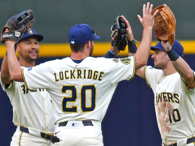 MILWAUKEE, WI - AUGUST 13: Blake Perkins #16 of the Milwaukee Brewers, Brandon Lockridge #20 of the Milwaukee Brewers, and Sal Frelick #10 of the Milwaukee Brewers celebrate after defeating the Pittsburgh Pirates in an MLB game on August 13, 2025, at American Family Field in Milwaukee, WI.