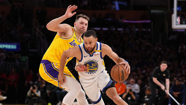 LOS ANGELES, CALIFORNIA - APRIL 03: Stephen Curry #30 of the Golden State Warriors drives against Luka Doncic #77 of the Los Angeles Lakers during the second half of a game at Crypto.com Arena on April 03, 2025 in Los Angeles, California.