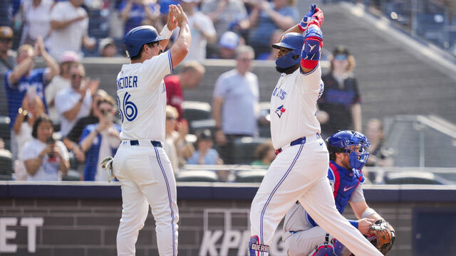 TORONTO, ON - AUGUST 14: Vladimir Guerrero Jr. #27 of the Toronto Blue Jays celebrates his two run home run with Davis Schneider #36 against the Chicago Cubs during the seventh inning in their MLB game at the Rogers Centre on August 14, 2025 in Toronto, Ontario, Canada.