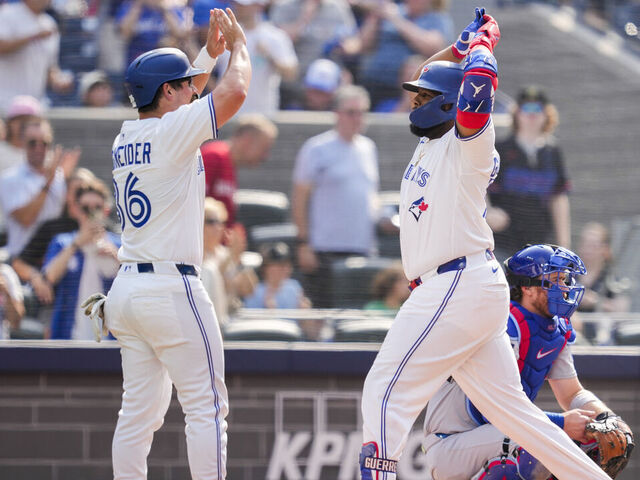 TORONTO, ON - AUGUST 14: Vladimir Guerrero Jr. #27 of the Toronto Blue Jays celebrates his two run home run with Davis Schneider #36 against the Chicago Cubs during the seventh inning in their MLB game at the Rogers Centre on August 14, 2025 in Toronto, Ontario, Canada.