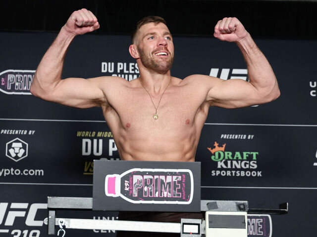 CHICAGO, ILLINOIS - AUGUST 15:Dricus Du Plessis poses on the scale during the UFC 319 official weigh-in at Voco Chicago Downtown on August 15, 2025 in Chicago, Illinois.