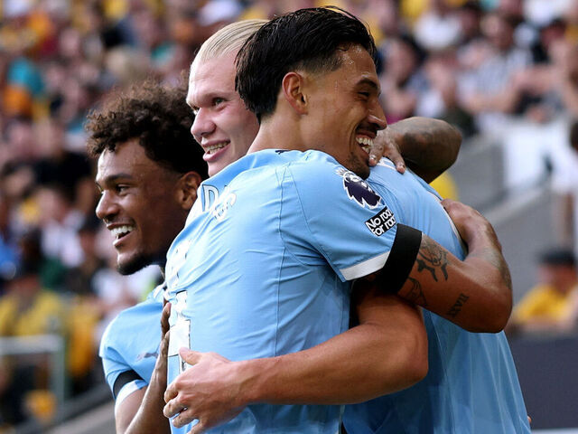 WOLVERHAMPTON, ENGLAND - AUGUST 16: Erling Haaland of Manchester City celebrates scoring his team's third goal with teammates Tijjani Reijnders and Oscar Bobb during the Premier League match between Wolverhampton Wanderers and Manchester City at Molineux on August 16, 2025 in Wolverhampton, England.