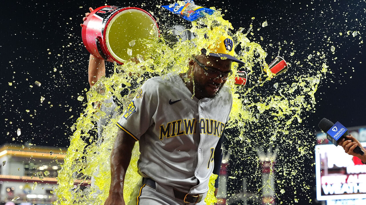 CINCINNATI, OHIO - AUGUST 16: Andruw Monasterio #14 of the Milwaukee Brewers doused with liquid after the game against the Cincinnati Reds at Great American Ball Park on August 16, 2025 in Cincinnati, Ohio. Milwaukee Brewers won 6-5.