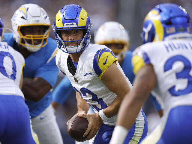 INGLEWOOD, CALIFORNIA - AUGUST 16: Stetson Bennett IV #13 of the Los Angeles Rams prepares a handoff to Jarquez Hunter #35 during the NFL Preseason 2025 game between Los Angeles Chargers and Los Angeles Rams at SoFi Stadium on August 16, 2025 in Inglewood, California.