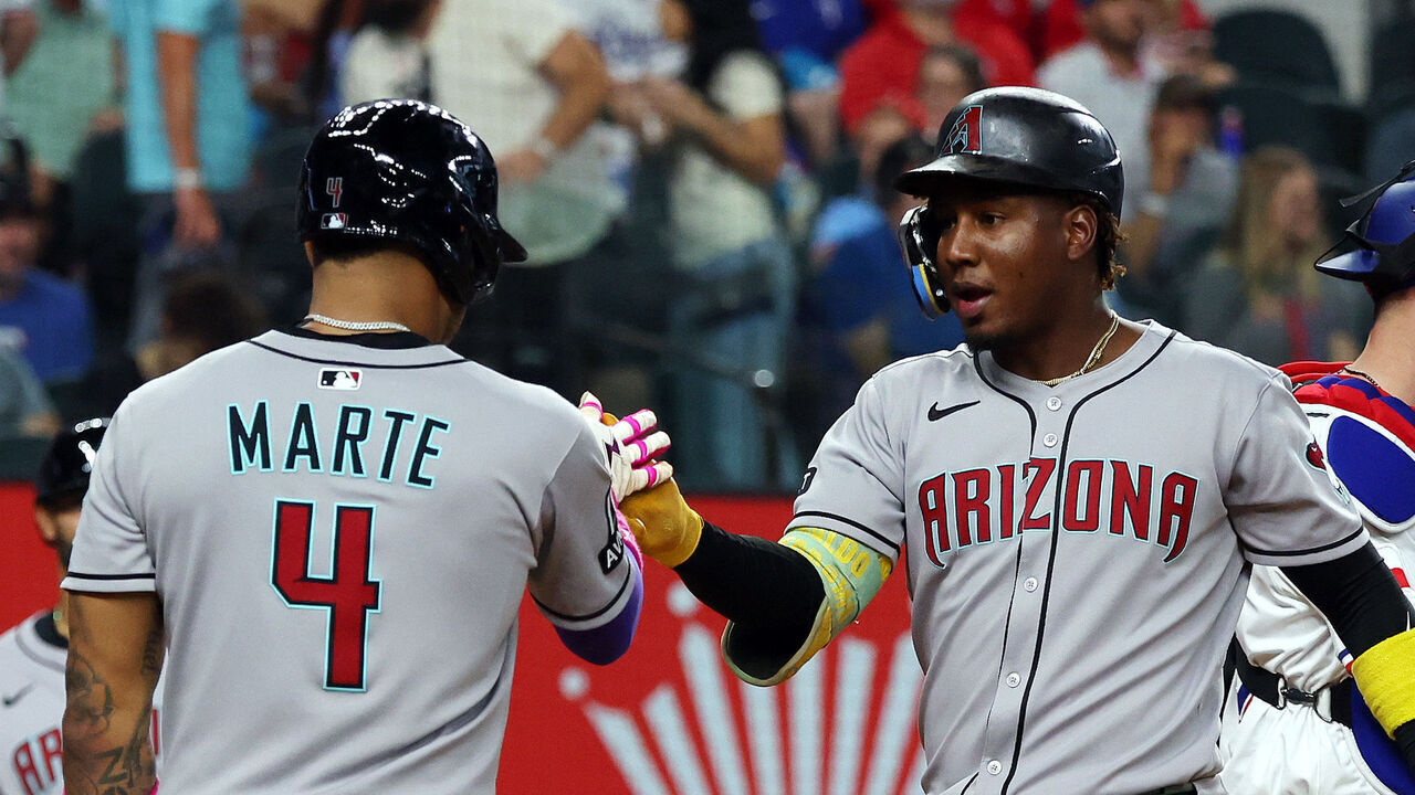 ARLINGTON, TEXAS - AUGUST 11: Ketel Marte #4 of the Arizona Diamondbacks celebrates with Geraldo Perdomo #2 of the Arizona Diamondbacks after Perdomo hit a home run against the Texas Rangers in the third inning at Globe Life Field on August 11, 2025 in Arlington, Texas.