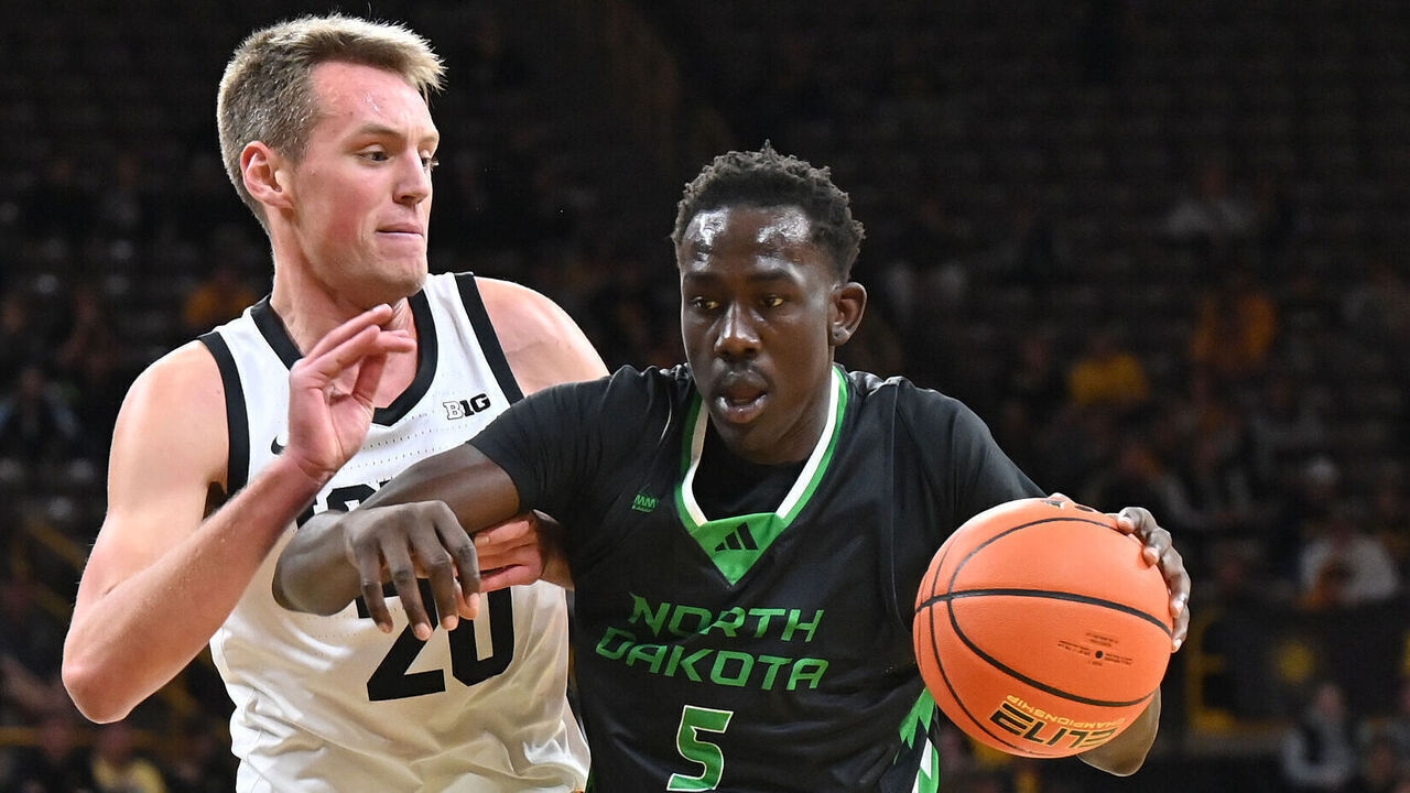 IOWA CITY, IA - NOVEMBER 07: North Dakota forward Deng Mayar (5) shoves Iowa forward Payton Sandfort (20) out of the way as he drives to the basket during a college basketball game between the North Dakota Fighting Hawks and the Iowa Hawkeyes on November 07, 2023, at Carver-Hawkeye Arena in Iowa City, IA.