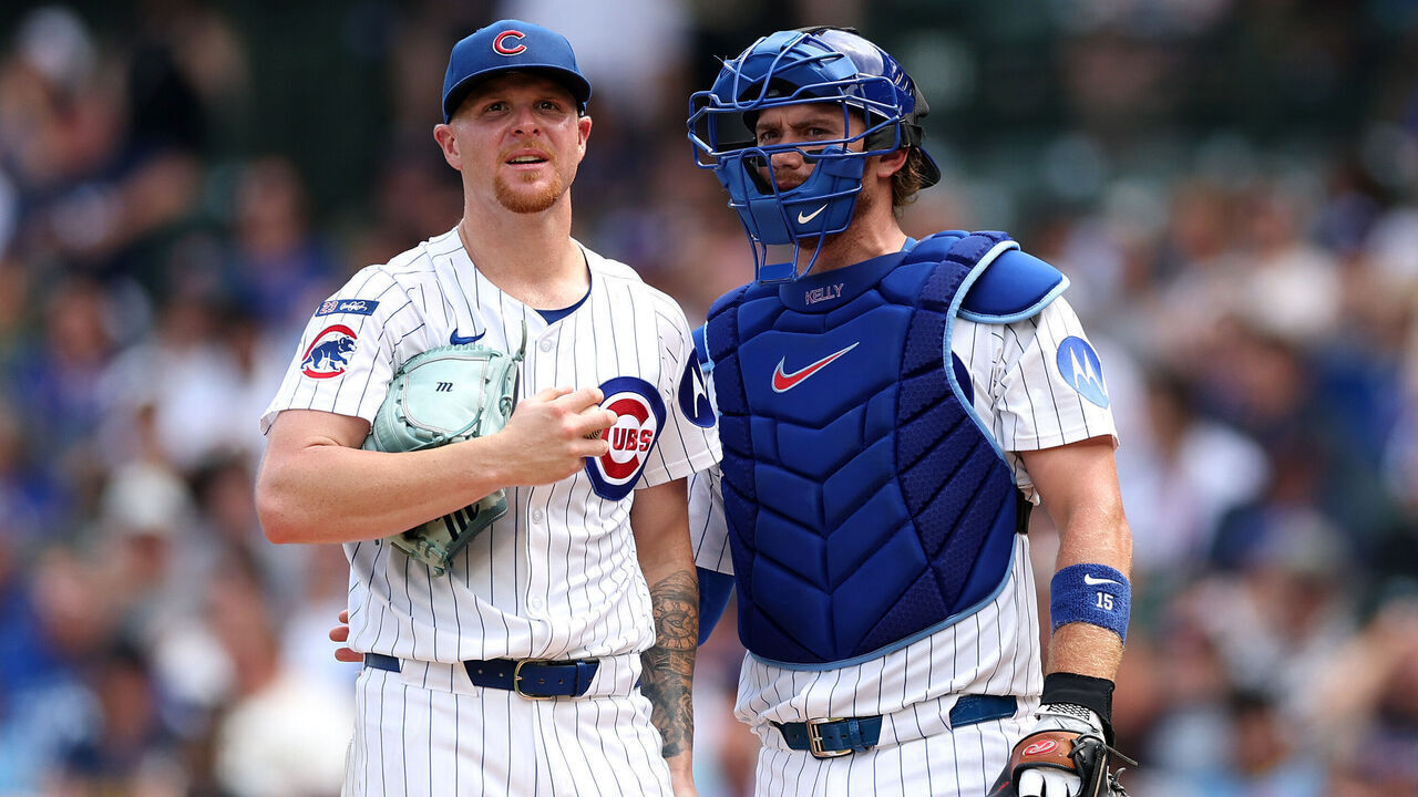 CHICAGO, ILLINOIS - AUGUST 18: Cade Horton #22 and Carson Kelly #15 of the Chicago Cubs meet for a mound visit against the Milwaukee Brewers during the third inning in game one of a doubleheader at Wrigley Field on August 18, 2025 in Chicago, Illinois.