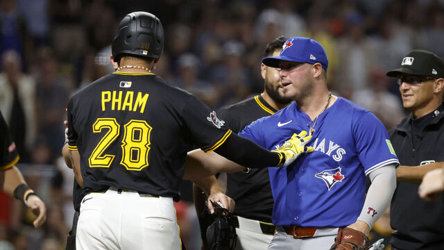 PITTSBURGH, PA - AUGUST 18: Tommy Pham #28 of the Pittsburgh Pirates pushes Ty France #2 of the Toronto Blue Jays after flipping his bat following a walk in the seventh inning at PNC Park on August 18, 2025 in Pittsburgh, Pennsylvania.