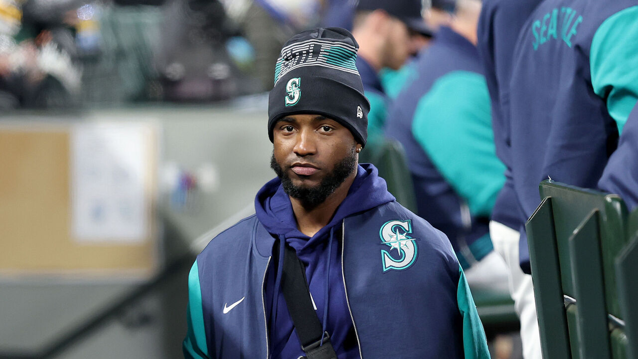 SEATTLE, WASHINGTON - APRIL 07: Victor Robles #10 of the Seattle Mariners looks on with his arm in a sling during the game against the Houston Astros at T-Mobile Park on April 07, 2025 in Seattle, Washington.
