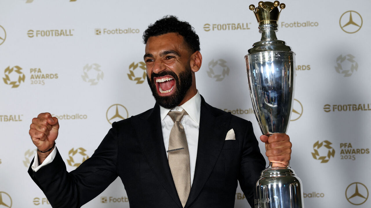 Liverpool's Egyptian striker Mohamed Salah poses with the Men's PFA Players' Player of the Year award backstage during the 2024-2025 Professional Footballers' Association (PFA) awards, at the Opera House in Manchester, northern England, on August 19, 2025.