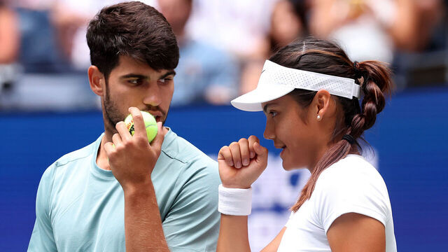 NEW YORK, NEW YORK - AUGUST 19: The doubles team of Emma Raducanu of Great Britain and Carlos Alcarez of Spain talk on the baseline during the mixed doubles first round match against Jessica Pegula of the United States and Jack Draper of Great Britain at USTA Billie Jean King National Tennis Center on August 19, 2025 in New York City.