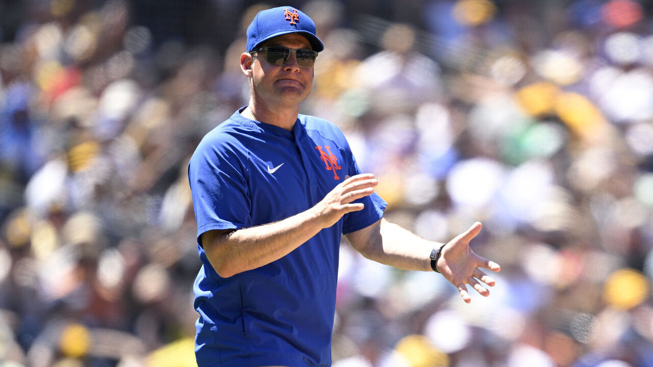 SAN DIEGO, CALIFORNIA - JULY 30: Manager Carlos Mendoza #64 of the New York Mets walks to the mound during the fourth inning against the San Diego Padres at Petco Park on July 30, 2025 in San Diego, California.