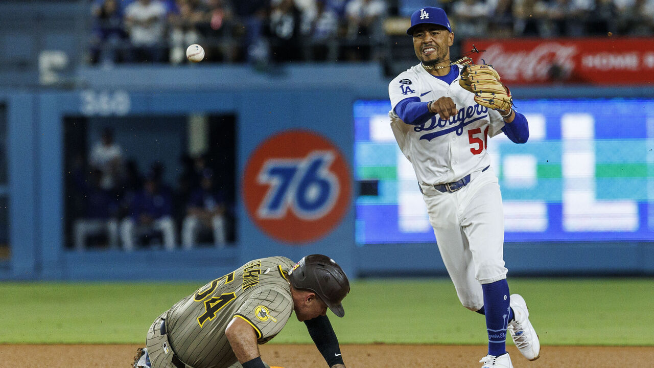 LOS ANGELES, CA - AUGUST 15, 2025: Los Angeles Dodgers shortstop Mookie Betts (50) throws to first base to complete the double play after getting out San Diego Padres catcher Freddy Fermin (54) in the fifth inning at Dodger Stadium on August 15, 2025 in Los Angeles, California.(Gina Ferazzi / Los Angeles Times via Getty Images)