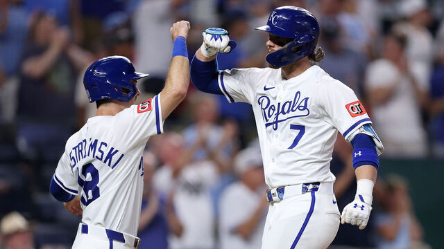 KANSAS CITY, MISSOURI - AUGUST 19: Bobby Witt Jr. #7 of the Kansas City Royals is congratulated by Mike Yastrzemski #18 after hitting his 100th career home run during the 8th inning of the game against the Texas Rangers at Kauffman Stadium on August 19, 2025 in Kansas City, Missouri.