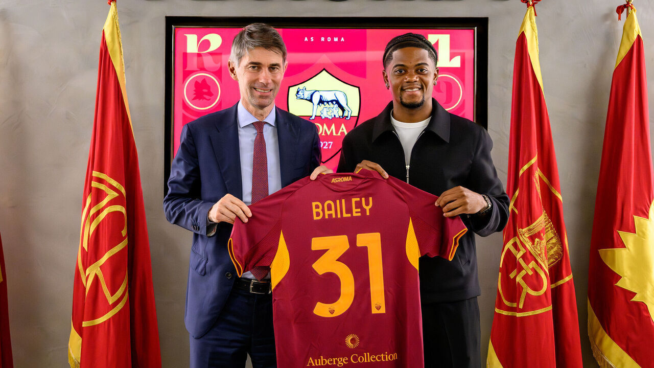 ROME, ITALY - AUGUST 20: AS Roma new signing Leon Bailey, with the Sports Director Frederic Massara, poses with his new jersey at Centro Sportivo Fulvio Bernardini on August 20, 2025 in Rome, Italy.
