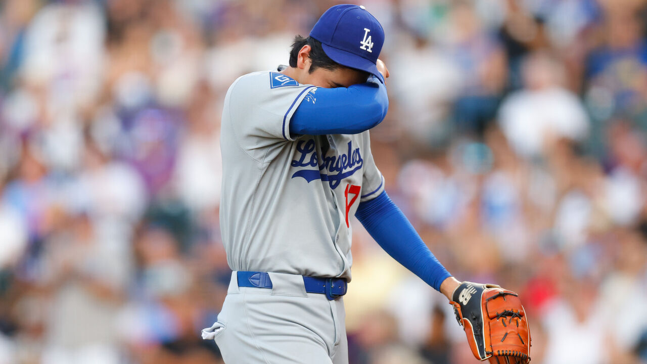 DENVER, CO - AUGUST 20: Shohei Ohtani #17 of the Los Angeles Dodgers wipes his forehead as he walks off the field in the second inning against the Colorado Rockies at Coors Field on August 20, 2025 in Denver, Colorado.