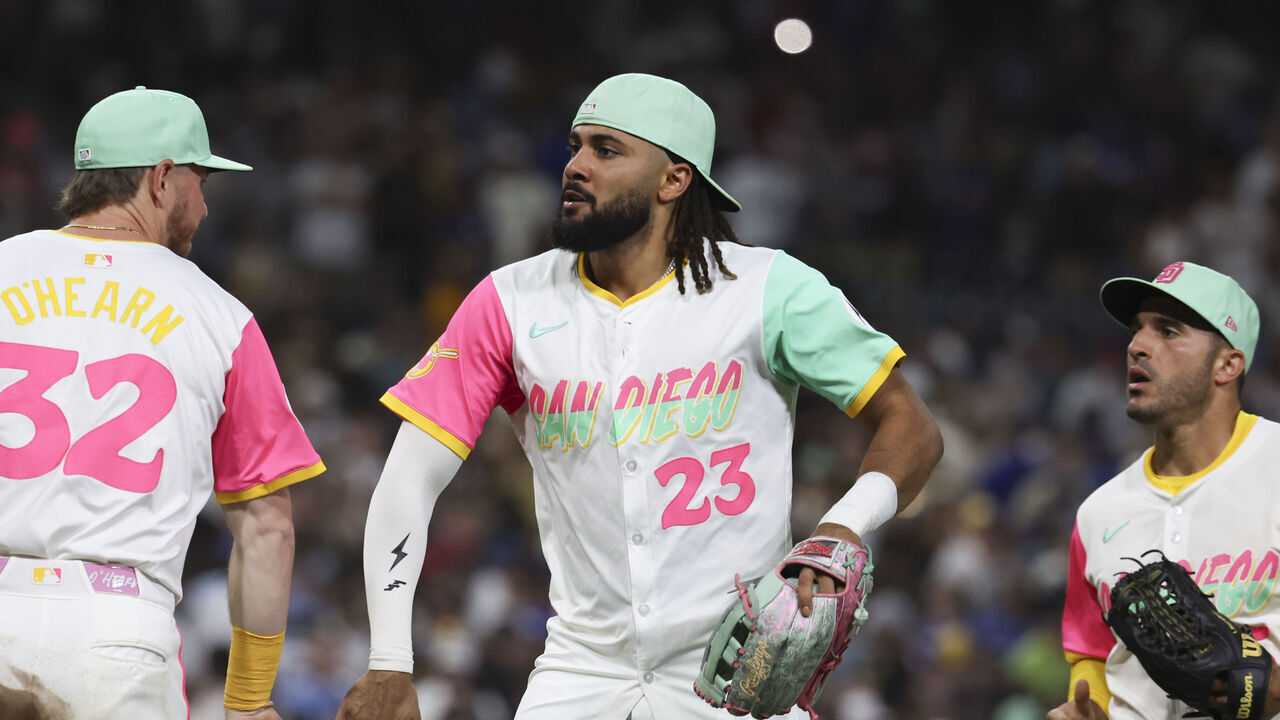 SAN DIEGO, CA - AUGUST 22: Fernando Tatis Jr. #23 of the San Diego Padres high-fives his teammates to celebrate a win after the game between the Los Angeles Dodgers and the San Diego Padres at Petco Park on Friday, August 22, 2025 in San Diego, California.