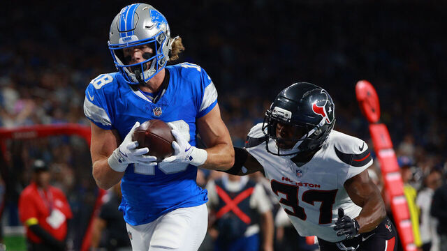 DETROIT,MICHIGAN-AUGUST 23: Detroit Lions wide receiver Isaac TeSlaa #18 scores a touchdown while guarded by Houston Texans cornerback D'Angelo Ross #37 during the first half of an NFL football game between the Houston Texans and the Detroit Lions in Detroit, Michigan USA, on Saturday, August 23, 2025
