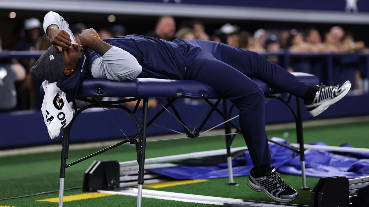 ARLINGTON, TEXAS - AUGUST 22: Micah Parsons #11 of the Dallas Cowboys lays on a training table during the second half of the NFL Preseason 2025 game against the Atlanta Falcons at AT&T Stadium on August 22, 2025 in Arlington, Texas.