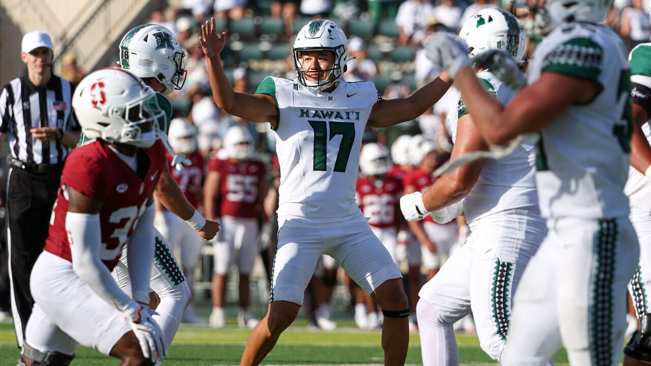 HONOLULU, HAWAII - AUGUST 23: Kansei Matsuzawa #17 of the Hawaii Rainbow Warriors raises his arms to celebrate with his teammates after kicking the game winning field goal during the second half against the Stanford Cardinal at the Clarence T.C. Ching Athletics Complex on August 23, 2025 in Honolulu, Hawaii.