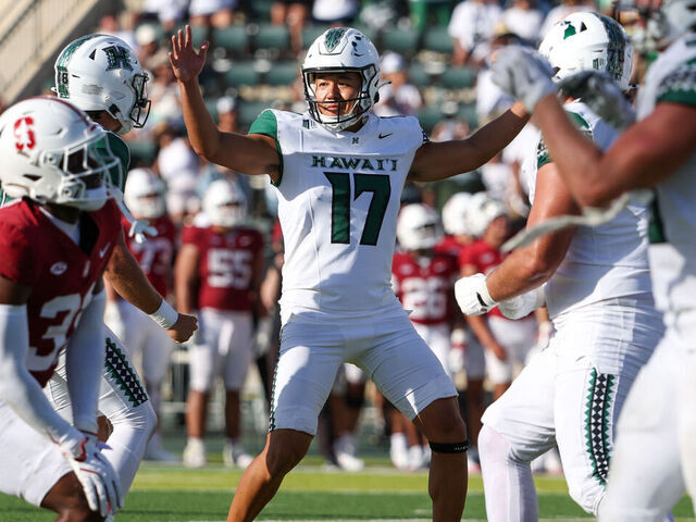HONOLULU, HAWAII - AUGUST 23: Kansei Matsuzawa #17 of the Hawaii Rainbow Warriors raises his arms to celebrate with his teammates after kicking the game winning field goal during the second half against the Stanford Cardinal at the Clarence T.C. Ching Athletics Complex on August 23, 2025 in Honolulu, Hawaii.