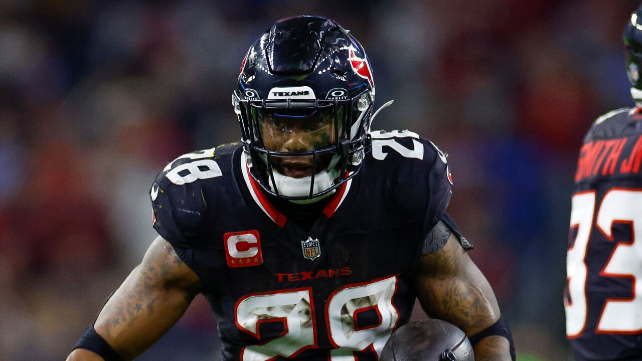 HOUSTON, TEXAS - JANUARY 11: Joe Mixon #28 of the Houston Texans carries the ball on a running play for a touchdown during the second half of the AFC Wild Card Playoff game against the Los Angeles Chargers at NRG Stadium on January 11, 2025 in Houston, Texas.