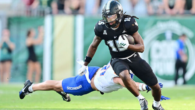 TAMPA, FLORIDA - AUGUST 28: Tayte Crable #15 of the South Florida Bulls breaks a tackle from Boen Phelps #41 of the Boise State Broncos in the first half of a game at Raymond James Stadium on August 28, 2025 in Tampa, Florida.