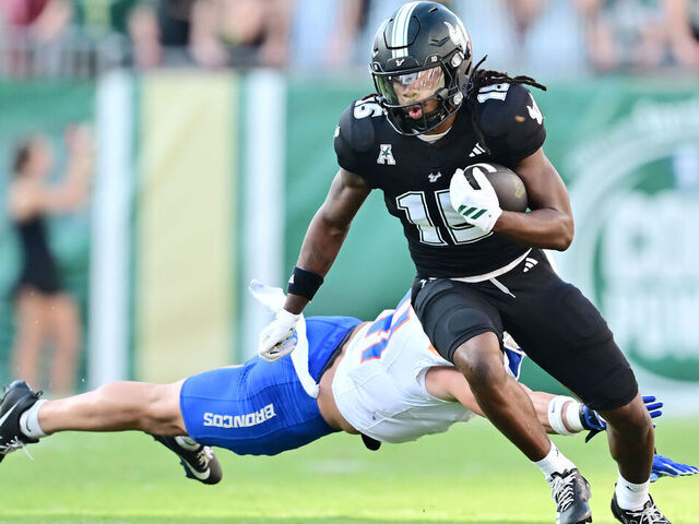 TAMPA, FLORIDA - AUGUST 28: Tayte Crable #15 of the South Florida Bulls breaks a tackle from Boen Phelps #41 of the Boise State Broncos in the first half of a game at Raymond James Stadium on August 28, 2025 in Tampa, Florida.