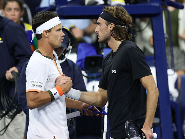Germany's Daniel Altmaier (L) shakes hands with Greece's Stefanos Tsitsipas after winning their men's singles second round tennis match on day five of the US Open tennis tournament at the USTA Billie Jean King National Tennis Center in New York City, on August 28, 2025.