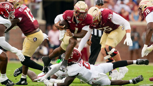 TALLAHASSEE, FL - AUGUST 30: Florida State Seminoles quarterback Tommy Castellanos (1) jumps over Alabama Crimson Tide linebacker Deontae Lawson (0) during a college football game between the Alabama Crimson Tide and the Florida State Seminoles on August 30th, 2025 at Doak Campbell Stadium in Tallahassee, FL.