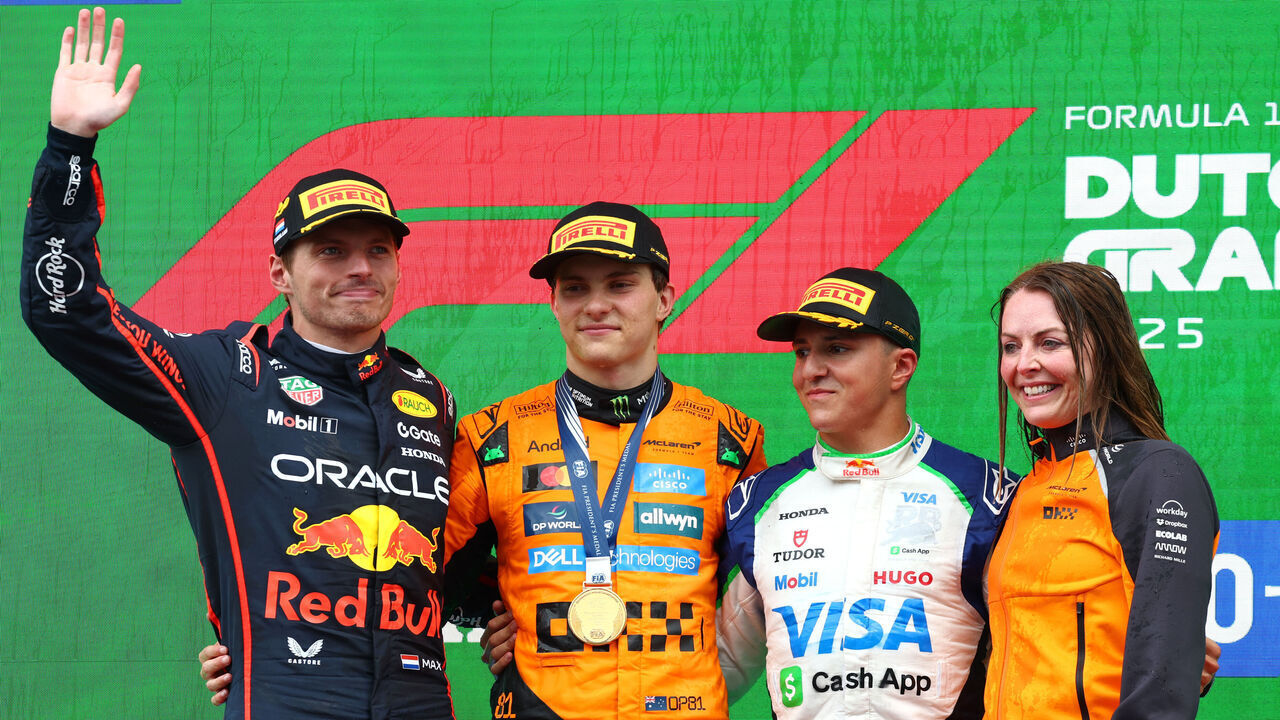 ZANDVOORT, NETHERLANDS - AUGUST 31: Race winner Oscar Piastri of Australia and McLaren Second placed Max Verstappen of the Netherlands and Oracle Red Bull Racing Third placed Isack Hadjar of France and Visa Cash App Racing Bulls and Laura Bowden, Chief Financial Officer at McLaren on the podium during the F1 Grand Prix of Netherlands at Circuit Zandvoort on August 31, 2025 in Zandvoort, Netherlands.