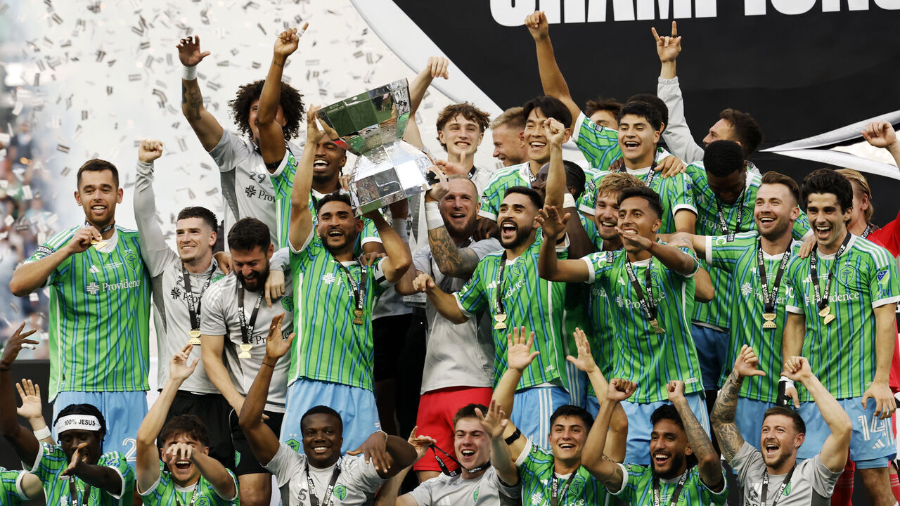 SEATTLE, WASHINGTON - AUGUST 31: Cristian Roldan #7 of the Seattle Sounders FC lifts the Champion's trophy after winning the Leagues Cup Final match between Seattle Sounders and Inter Miami CF at Lumen Field on August 31, 2025 in Seattle, Washington.
