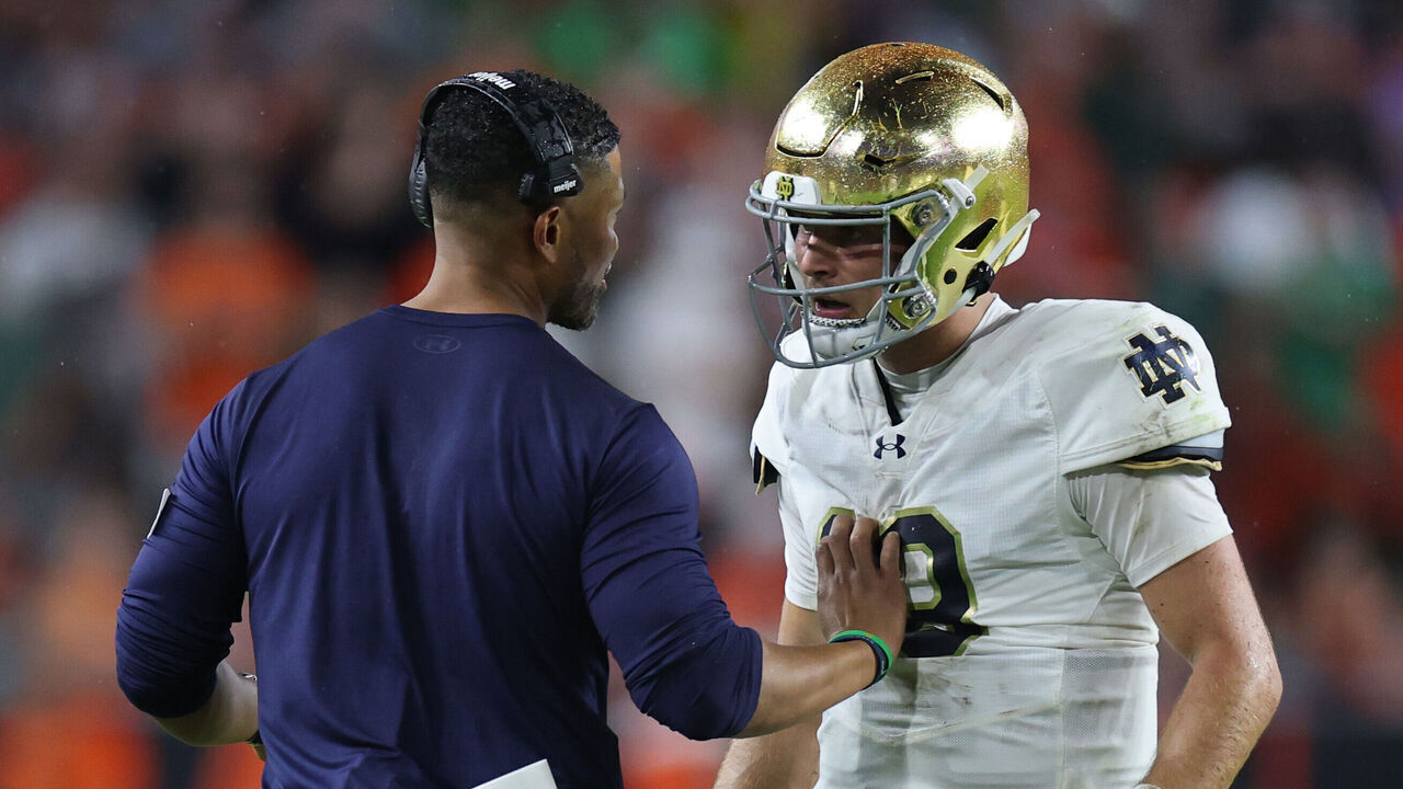 MIAMI GARDENS, FLORIDA - AUGUST 31: Head coach Marcus Freeman speaks with CJ Carr #13 of the Notre Dame Fighting Irish during the first half against the Miami Hurricanes at Hard Rock Stadium on August 31, 2025 in Miami Gardens, Florida.