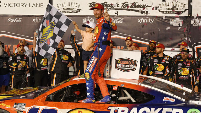 DARLINGTON, SC - AUGUST 31: Chase Briscoe (#19 Joe Gibbs Racing Bass Pro Shops Toyota) and his son Brooks celebrates in Victory Lane following the running of the NASCAR Cup Series Cook Out Southern 500 on August 31, 2025, at Darlington Raceway in Darlington, SC.
