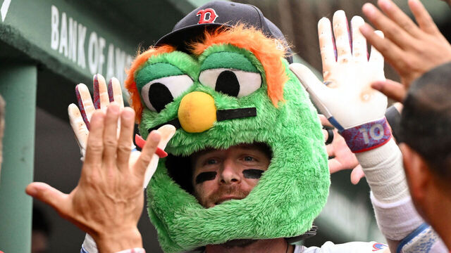 BOSTON, MASSACHUSETTS - SEPTEMBER 01: Trevor Story #10 of the Boston Red Sox celebrates with his teammates wearing a mascot mask after hitting a solo home run against the Cleveland Guardians during the sixth inning at Fenway Park on September 01, 2025 in Boston, Massachusetts.