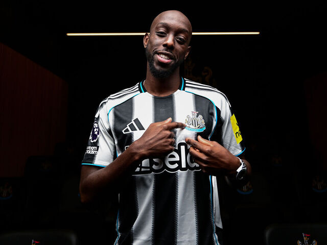 NEWCASTLE UPON TYNE, ENGLAND - SEPTEMBER 01: Yoane Wissa poses for photographs wearing a home shirt at the Newcastle United Training Centre after signing for the club on September 01, 2025 in Newcastle upon Tyne, England.