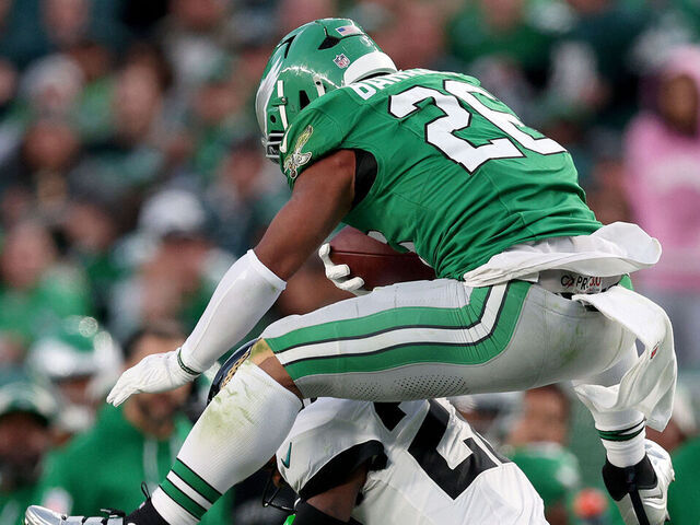 PHILADELPHIA, PENNSYLVANIA - NOVEMBER 03: Saquon Barkley #26 of the Philadelphia Eagles reverse hurdles over Jarrian Jones #22 of the Jacksonville Jaguars in the second quarter at Lincoln Financial Field on November 03, 2024 in Philadelphia, Pennsylvania.