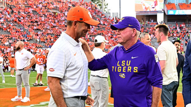 CLEMSON, SC - AUGUST 30: Head coach Dabo Swinney of the Clemson Tigers speaks with head coach Brian Kelly of the LSU Tigers before a game against the Clemson Tigers on August 30, 2025 at Memorial Stadium in Clemson, South Carolina.
