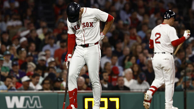BOSTON, MA - SEPTEMBER 2: Roman Anthony #19 of the Boston Red Sox holds his lower back as he heads for the dugout after swinging and missing at a third strike during the fourth inning at Fenway Park on September 2, 2025 in Boston, Massachusetts.