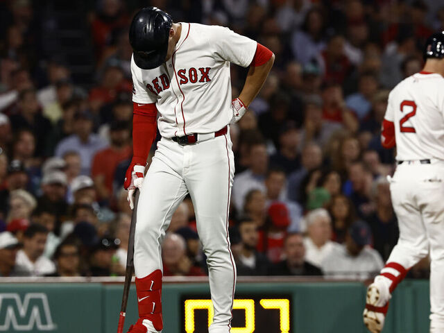 BOSTON, MA - SEPTEMBER 2: Roman Anthony #19 of the Boston Red Sox holds his lower back as he heads for the dugout after swinging and missing at a third strike during the fourth inning at Fenway Park on September 2, 2025 in Boston, Massachusetts.