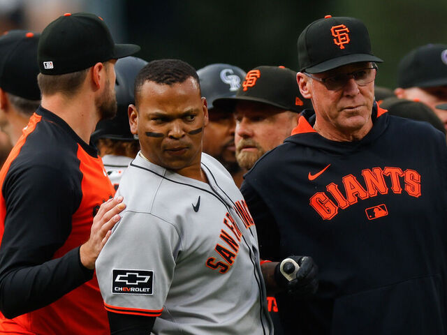 DENVER, CO - SEPTEMBER 2: Rafael Devers #16 and Manager Bob Melvin of the San Francisco Giants stand on the field during an altercation with the Colorado Rockies after Starting pitcher Kyle Freeland #21 of the Colorado Rockies took exception with Devers following a two-run home run by Devers in the first inning at Coors Field on September 2, 2025 in Denver, Colorado.