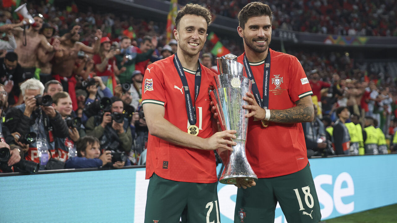 MUNICH, GERMANY - JUNE 08: Diogo Jota of Portugal and Ruben Neves pose for a photograph with the UEFA Nations League trophy after his team's victory in the UEFA Nations League 2025 final match between Portugal and Spain at Munich Football Arena on June 08, 2025 in Munich, Germany.
