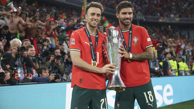 MUNICH, GERMANY - JUNE 08: Diogo Jota of Portugal and Ruben Neves pose for a photograph with the UEFA Nations League trophy after his team's victory in the UEFA Nations League 2025 final match between Portugal and Spain at Munich Football Arena on June 08, 2025 in Munich, Germany.